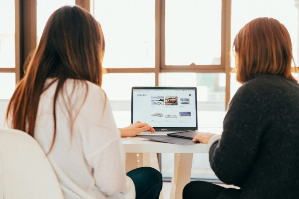 Two professionals collaborating at a laptop
